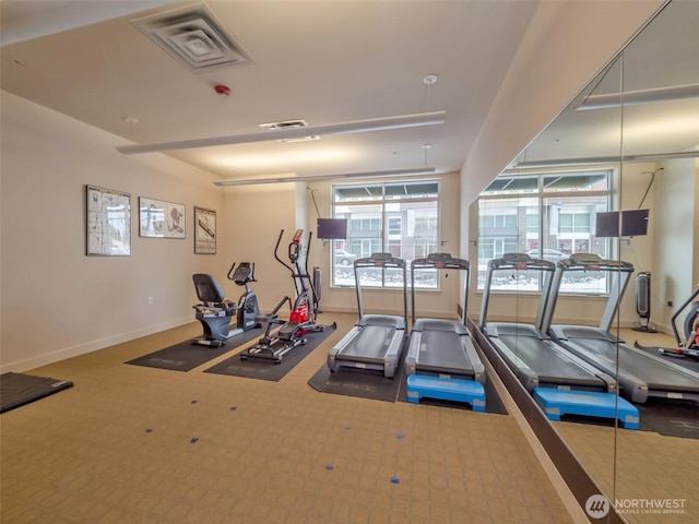 gym featuring plenty of natural light, visible vents, and baseboards