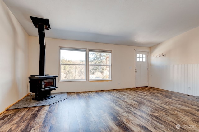 living room with hardwood / wood-style floors and a wood stove