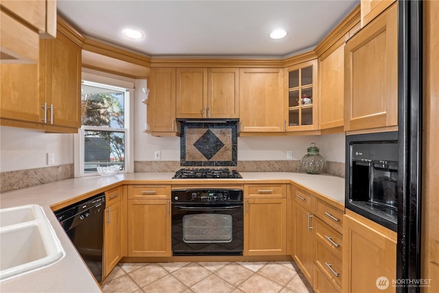 kitchen featuring sink, black appliances, and light tile patterned flooring