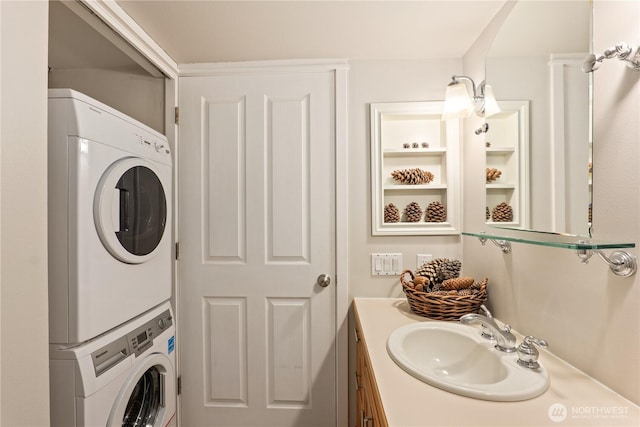 clothes washing area featuring stacked washer / drying machine and sink