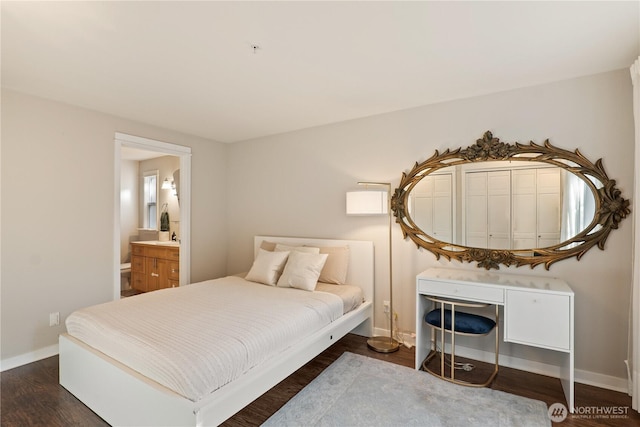 bedroom with ensuite bathroom and dark hardwood / wood-style flooring