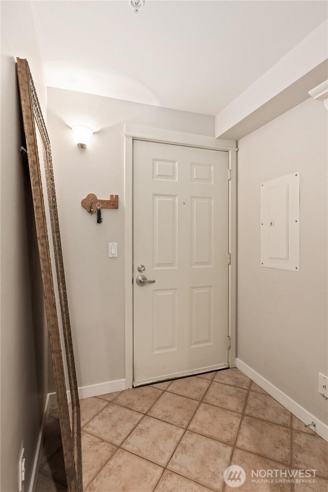 entryway with electric panel and light tile patterned flooring