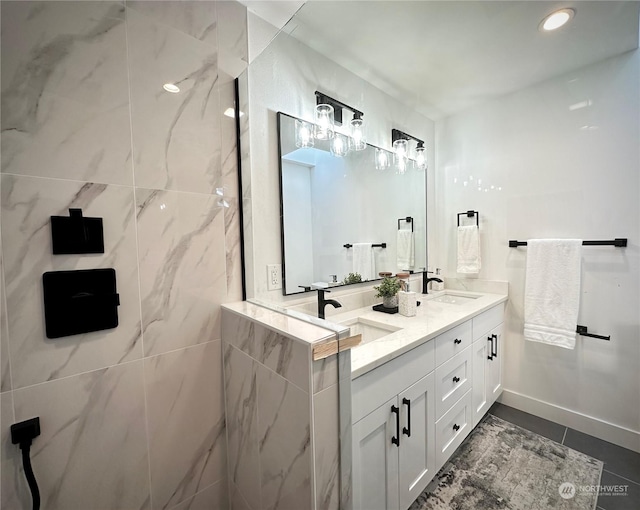 bathroom featuring double vanity, a sink, and recessed lighting