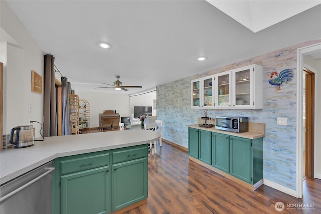 kitchen with appliances with stainless steel finishes, white cabinets, dark hardwood / wood-style flooring, and green cabinetry