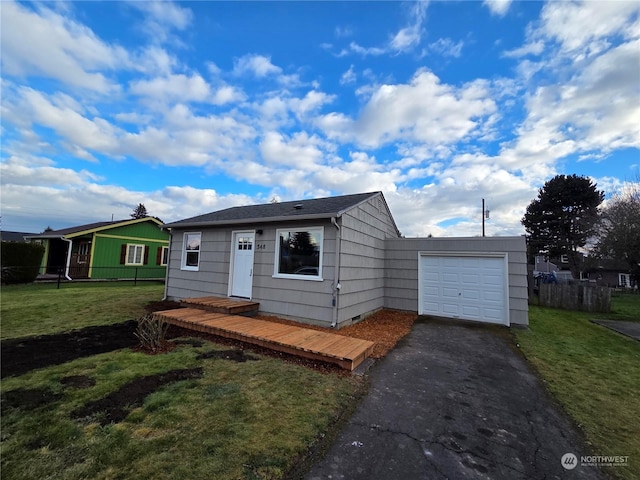 view of front of home with a garage and a front lawn