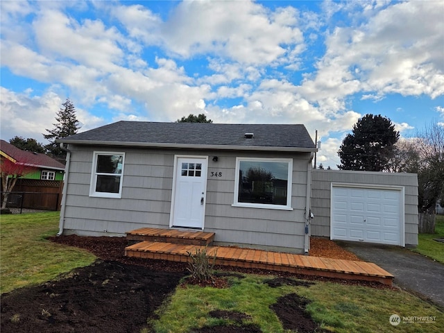 view of front facade with a garage and a front lawn