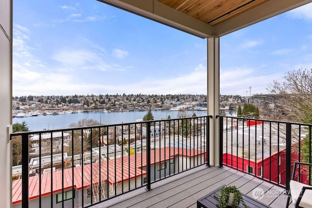 deck featuring a balcony and a water view