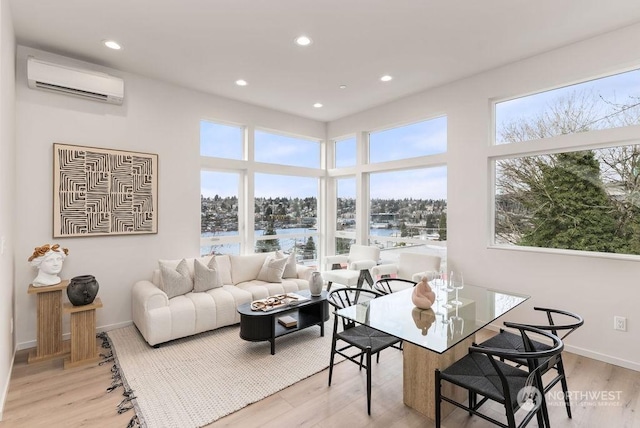 sunroom / solarium with a wall mounted air conditioner and a water view