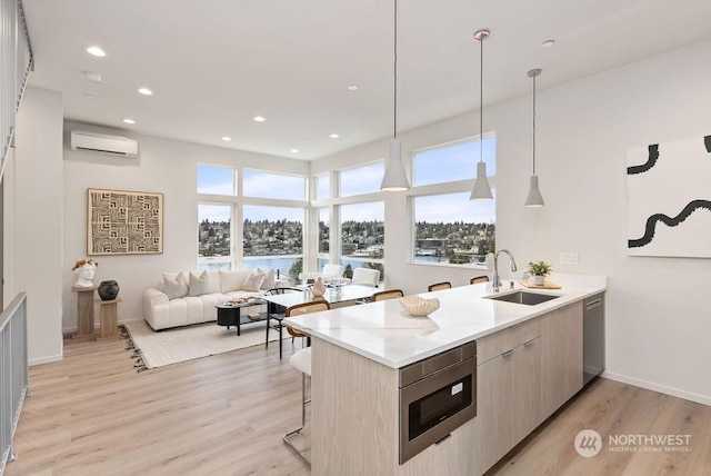 kitchen featuring hanging light fixtures, stainless steel appliances, a wall mounted air conditioner, light stone countertops, and a kitchen bar