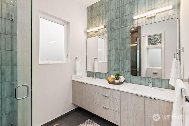 bathroom with vanity, tile walls, tile patterned floors, and a shower with shower door