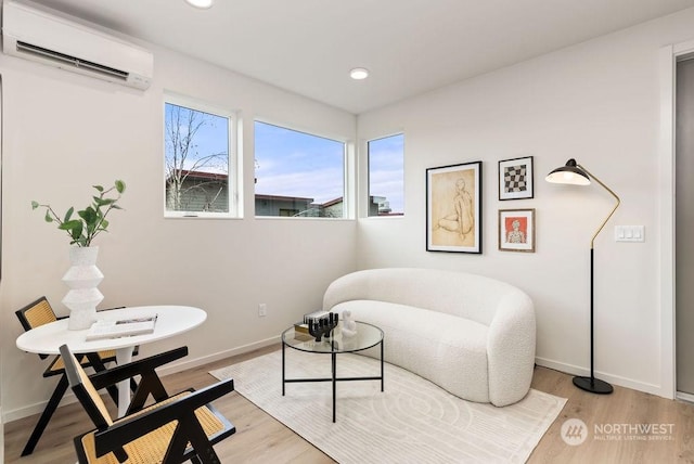 interior space with an AC wall unit and light hardwood / wood-style flooring