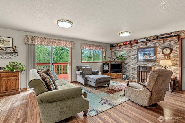 living area with a textured ceiling and wood finished floors