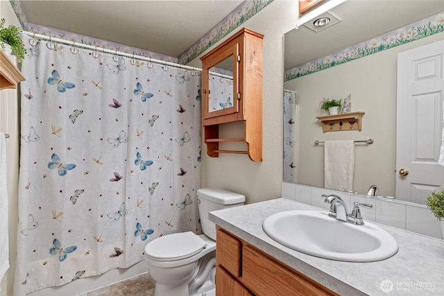 full bath with toilet, shower / bath combination with curtain, and vanity