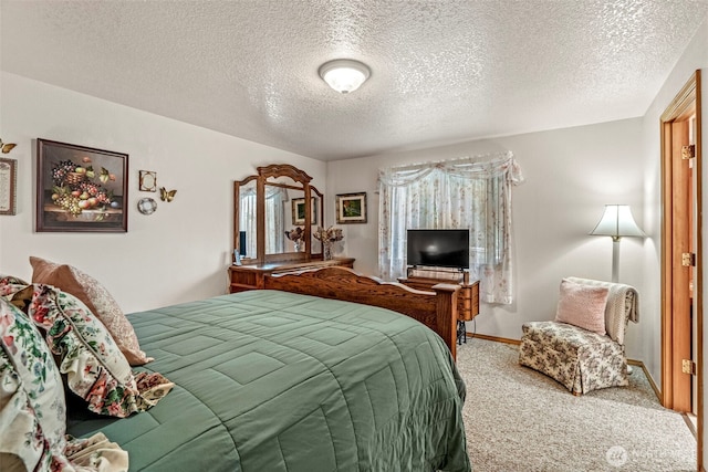 bedroom with carpet floors, baseboards, and a textured ceiling