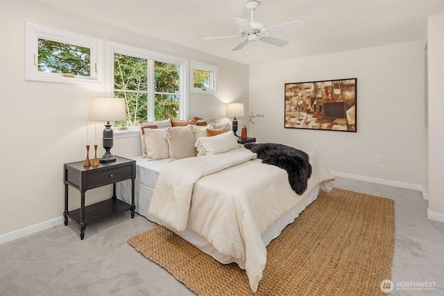 bedroom featuring baseboards, ceiling fan, and light colored carpet