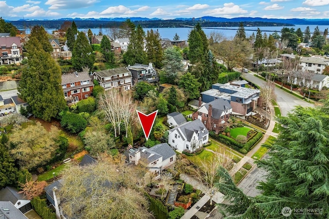 birds eye view of property with a residential view and a water and mountain view