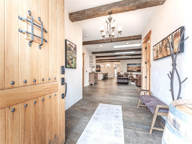 foyer entrance featuring a notable chandelier, dark wood-type flooring, and beamed ceiling