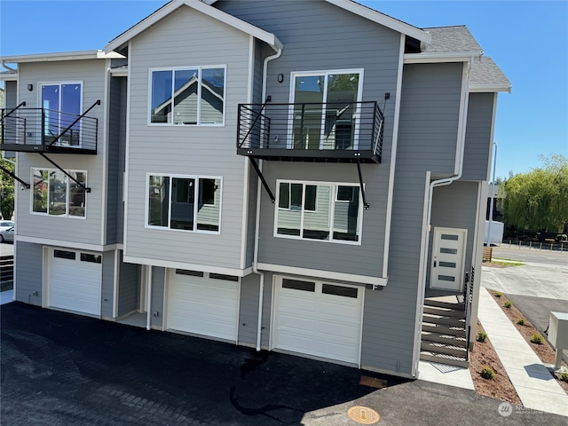 view of front facade featuring a garage and a balcony