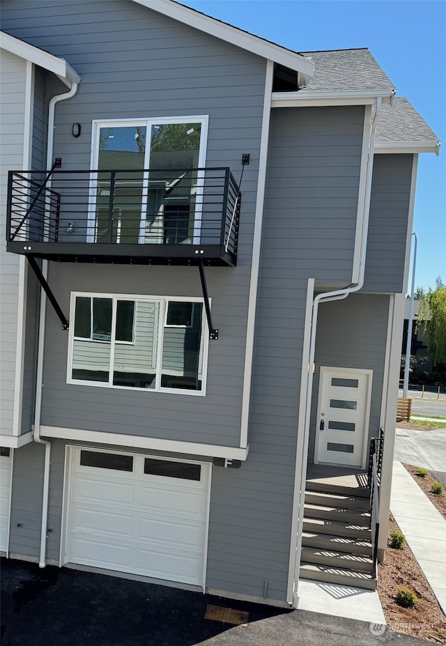 view of front of home with a balcony and a garage