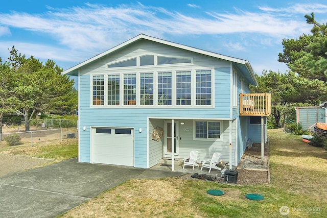 view of front of property with a garage and a front yard