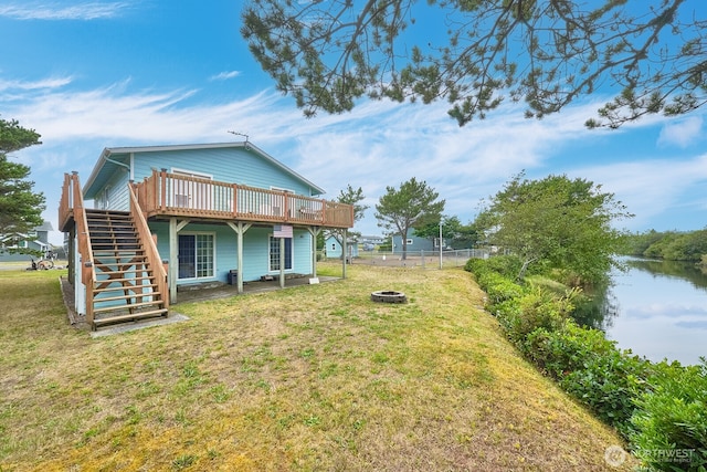32208 G St, Ocean Park, WA 98640 - back of house featuring a deck with water view, an outdoor fire pit, and a lawn