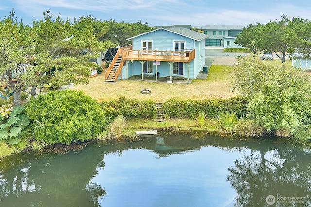 32208 G St, Ocean Park, WA 98640 - rear view of house with a deck with water view, a lawn, and an outdoor fire pit