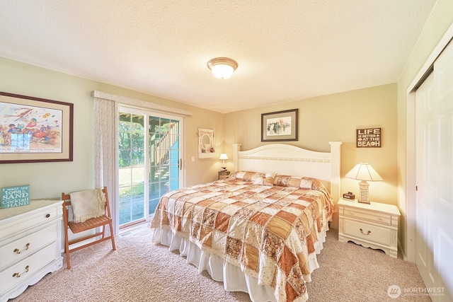 32208 G St, Ocean Park, WA 98640 - carpeted bedroom featuring access to exterior, a closet, and a textured ceiling