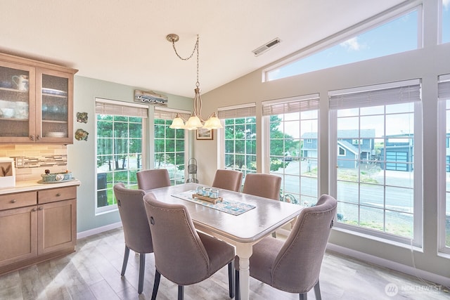32208 G St, Ocean Park, WA 98640 - dining area with light wood-type flooring, vaulted ceiling, and a notable chandelier