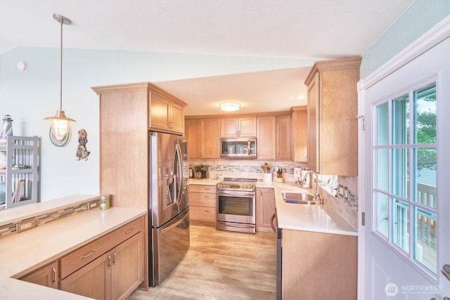 32208 G St, Ocean Park, WA 98640 - kitchen with lofted ceiling, sink, decorative light fixtures, light hardwood / wood-style flooring, and stainless steel appliances