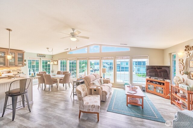 32208 G St, Ocean Park, WA 98640 - living room featuring ceiling fan, lofted ceiling, hardwood / wood-style floors, and a textured ceiling