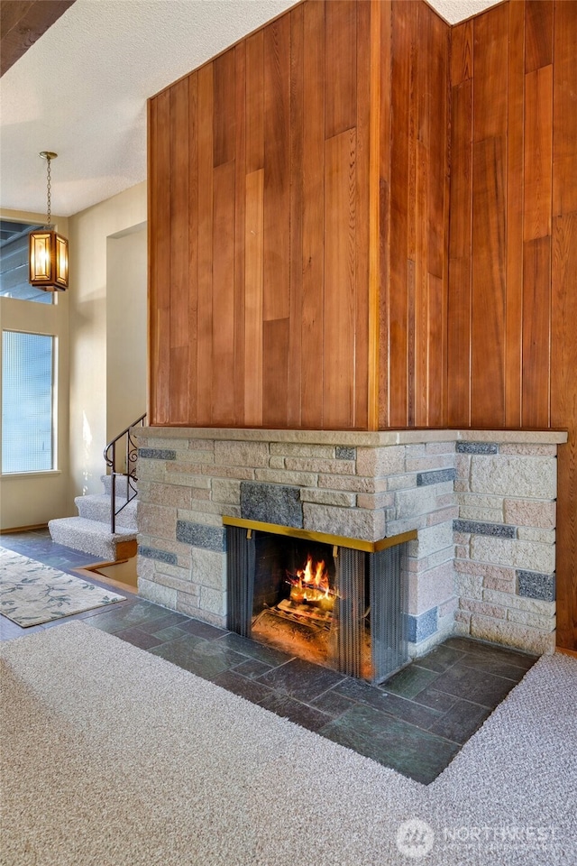 details featuring carpet flooring, a textured ceiling, and a fireplace