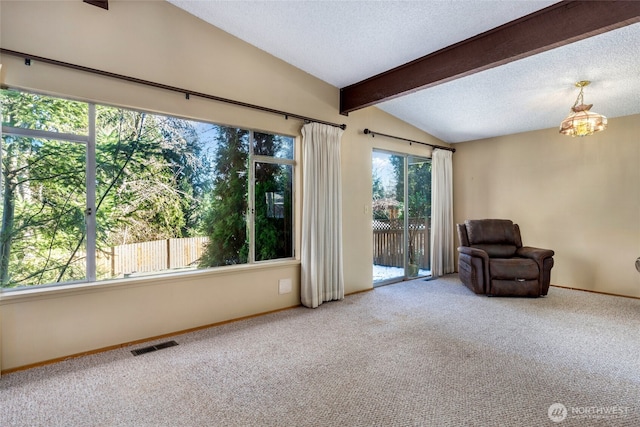 sitting room with carpet floors, vaulted ceiling with beams, a chandelier, and a textured ceiling