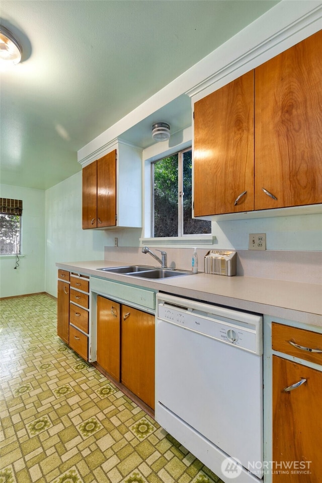 kitchen featuring white dishwasher and sink