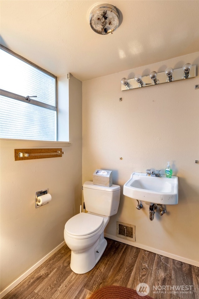 bathroom featuring sink, hardwood / wood-style floors, and toilet