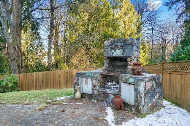 view of patio with an outdoor stone fireplace