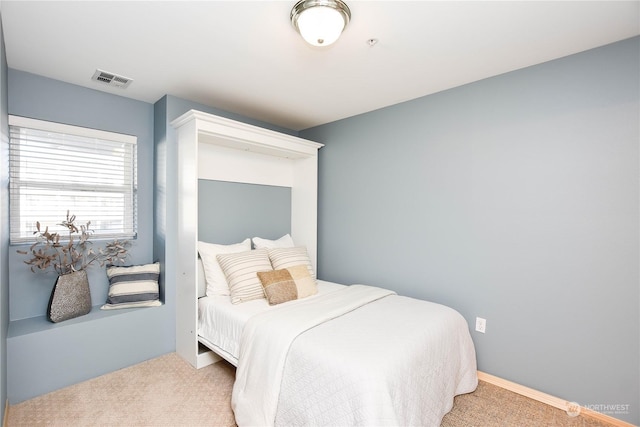 bedroom with light colored carpet