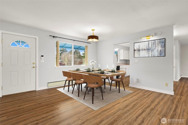 dining area with hardwood / wood-style flooring and a baseboard radiator