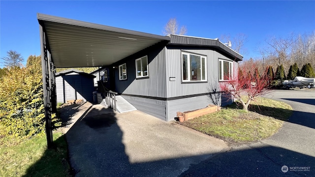 view of side of home with a carport