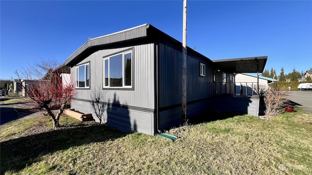 view of side of property with a lawn