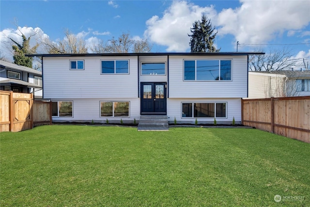 back of property featuring french doors and a yard