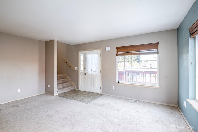 view of carpeted foyer entrance