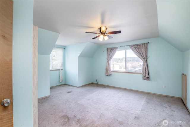 additional living space with ceiling fan, vaulted ceiling, and light carpet