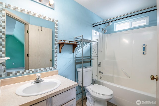 full bathroom featuring vanity, bathing tub / shower combination, and toilet