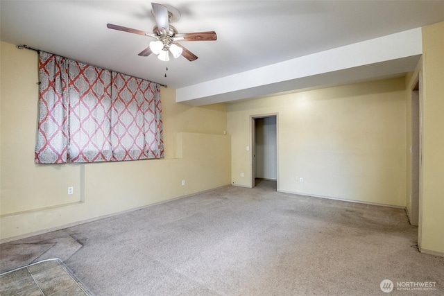 carpeted spare room featuring ceiling fan