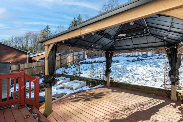 snow covered deck featuring a gazebo