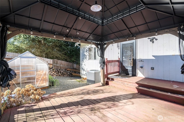 deck featuring an outbuilding, central AC, and a gazebo