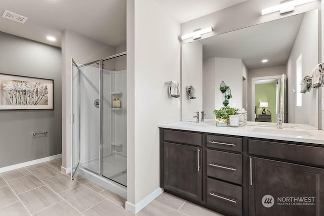 bathroom featuring vanity, an enclosed shower, and tile patterned floors