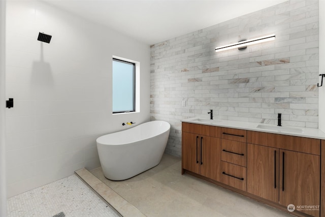 bathroom with vanity, tile walls, and plus walk in shower