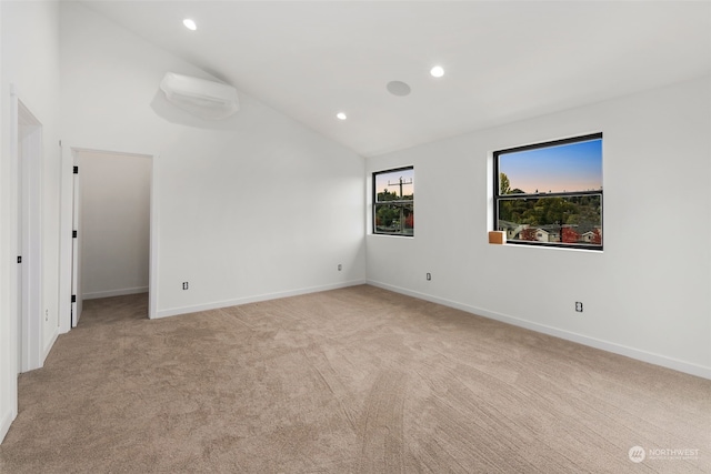 spare room with light carpet and high vaulted ceiling