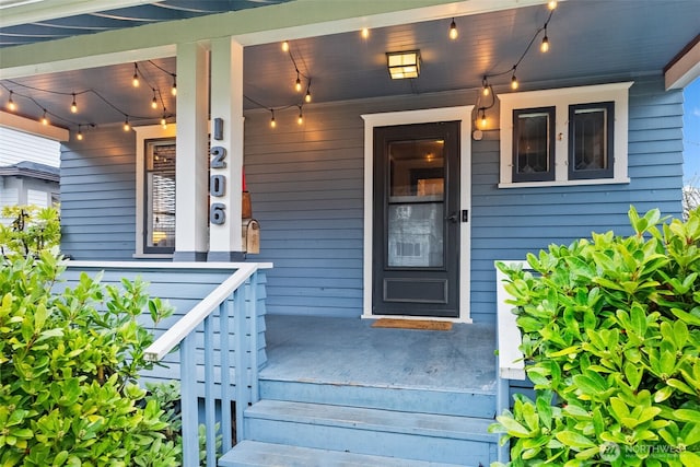 view of exterior entry with a porch